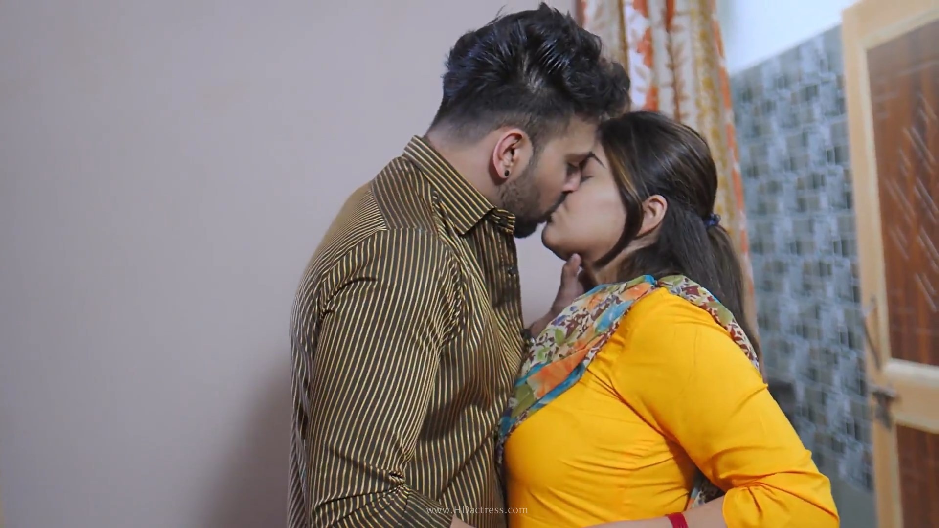 Shafaq Naaz Angithee 2 still, Kavya in a romantic pose, liplock frame, film screenshot, warm tones