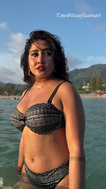 Sofia Ansari bikini photo, beach pose, busty curves, black hair, temptress tease look