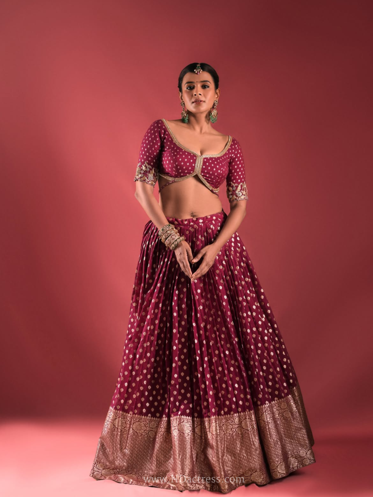 Hebah Patel side profile in fitted sweetheart blouse with soft lighting accentuating her figure