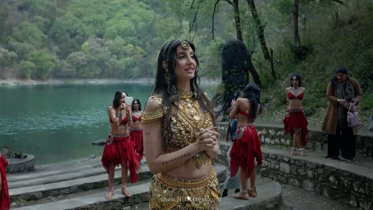 Nora Fatehi mid-body roll in shimmering outfit during Body Roll BTS shoot

