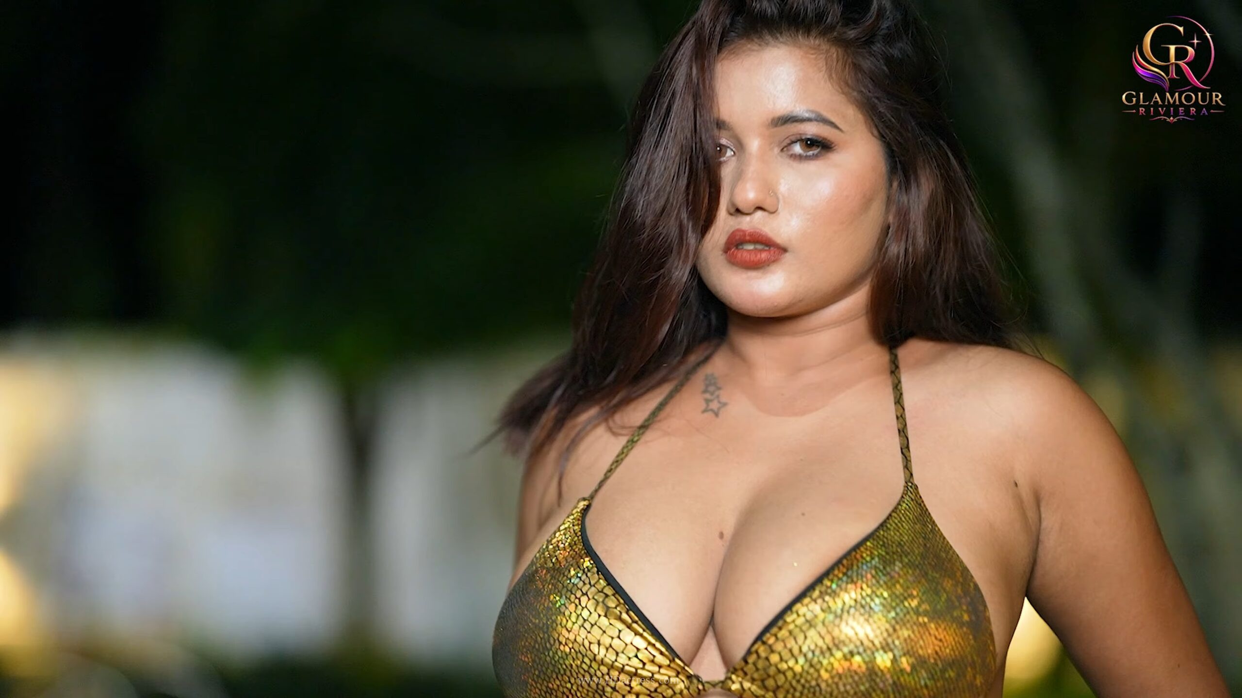 Shital Shaw posing confidently in a golden sexy bikini under warm golden-hour light  

